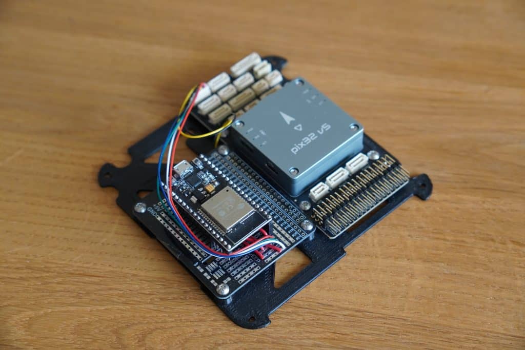 pix32V5 flight controller with DroneBridge for ESP32 transmitter mounted on a base plate that goes into the main frame
